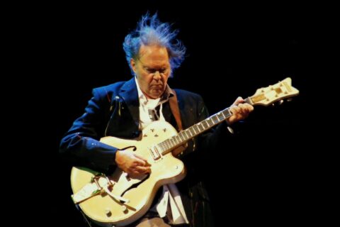 Neil Young tocando violão em apresentação